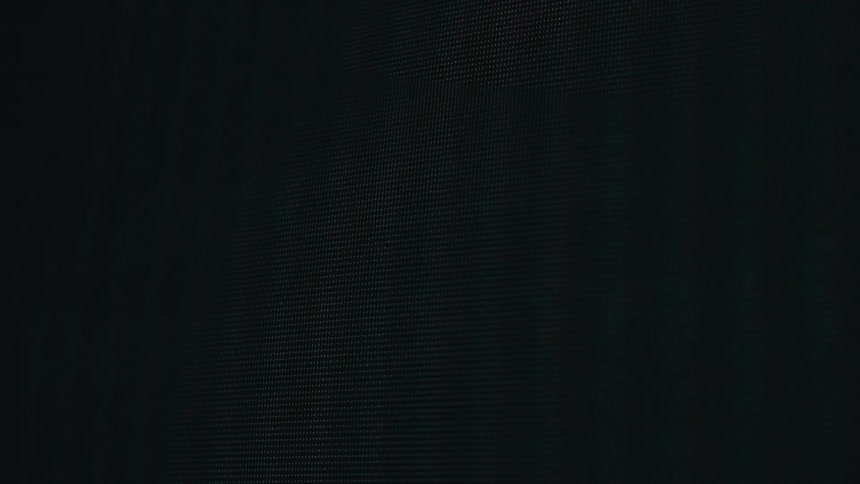 A closeup shot of a digital screen displaying the blinking text access requested in white pixelated font which eventually changes to access granted in green