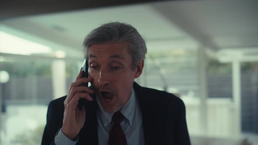 A man is talking on his cell phone at home