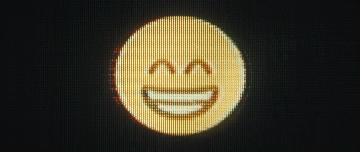 Pixelated emojis smiling and laughing on a computer screen