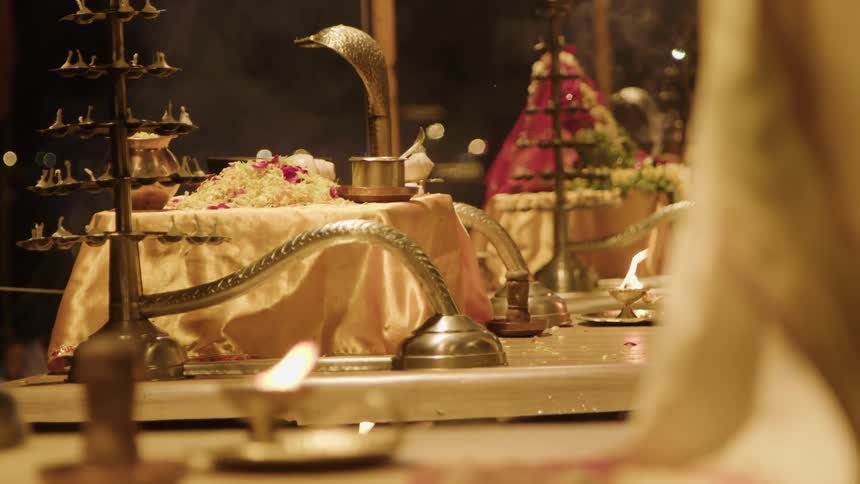 Festive table with a ritual of golden metals of fire