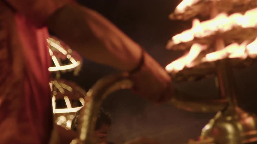 People holding chalices of fire in a performance