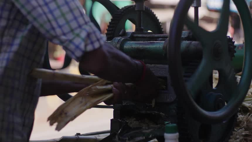 A man is crushing wood with a machine