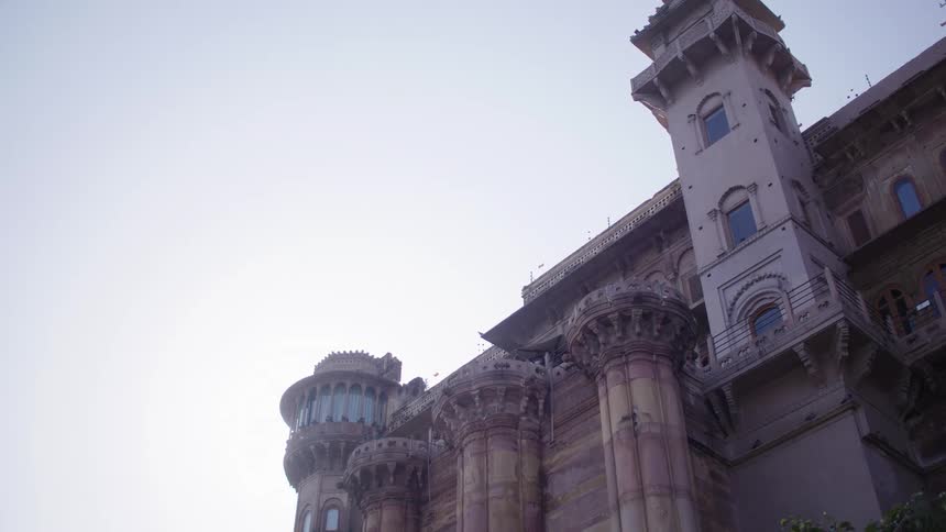 Birds flying near a classical building