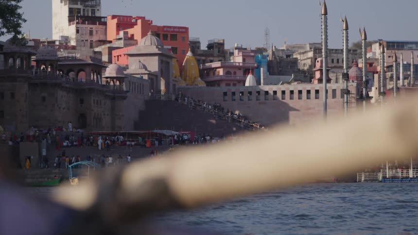 Landscape of a sea canal with a city in the background and a crowd of people walking