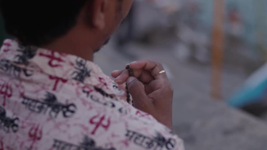 Close up of a persons hands holding a rosary