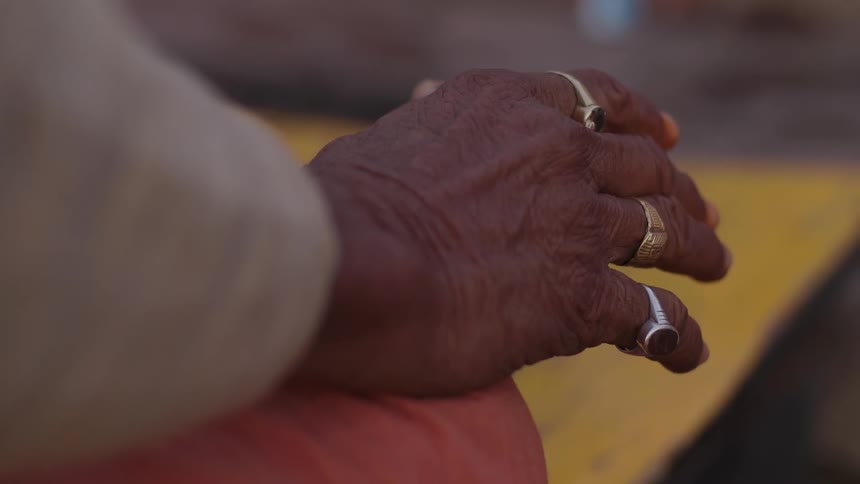 Close up of a persons hand with several rings