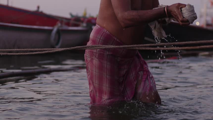 Person bathing in the sea and washing clothes