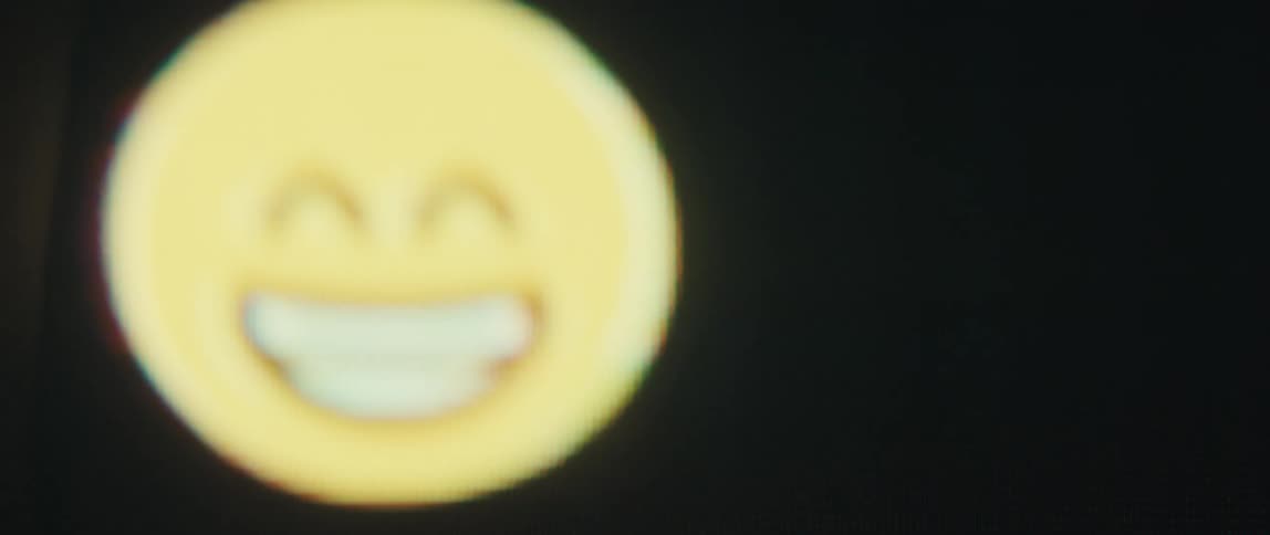 Close up of a screen displaying happy emojis