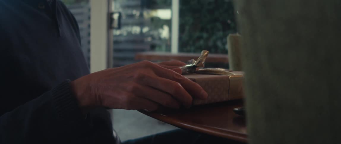 Hands of a person arranging the bow of a gift