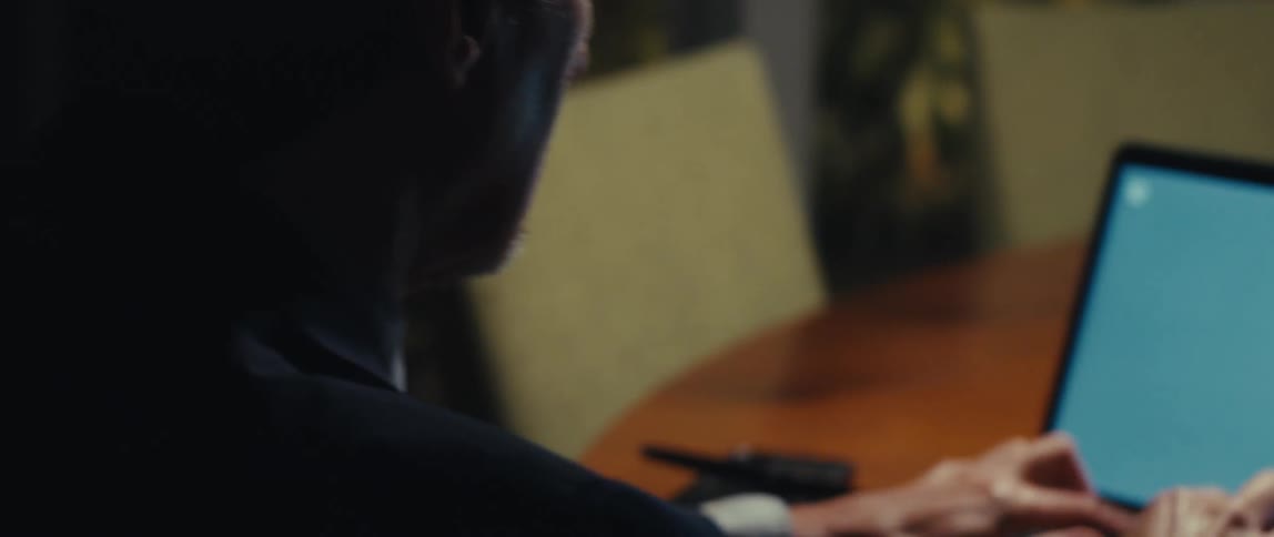 Man sitting typing on a laptop