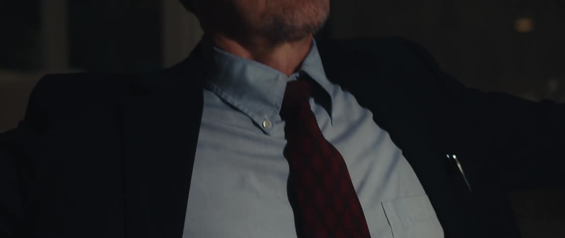 A man types on his laptop then smiles