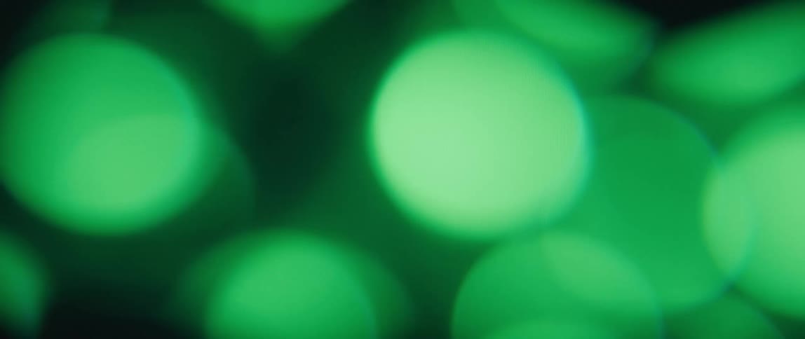 Close up of several green circular lights