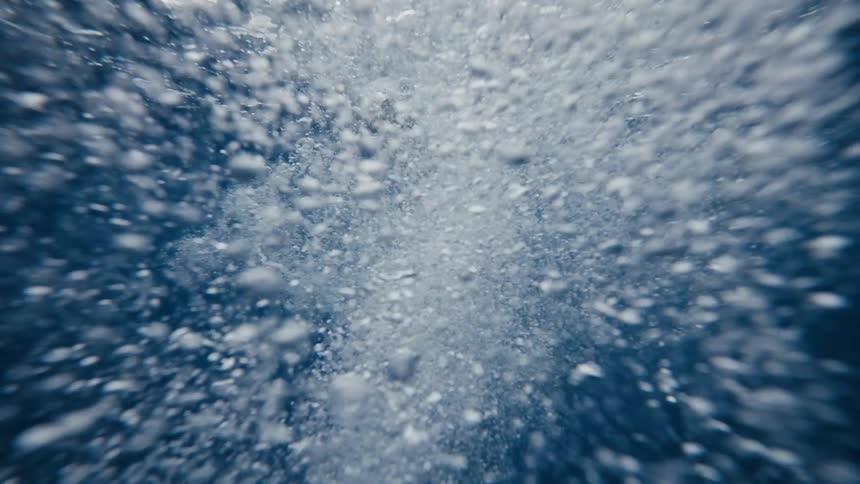 Following a couple of underwater swimmers as they leave a trail of air bubbles behind them