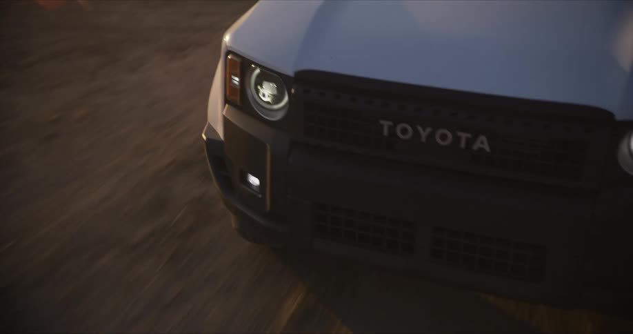 Front of a white toyota car on a dirt road