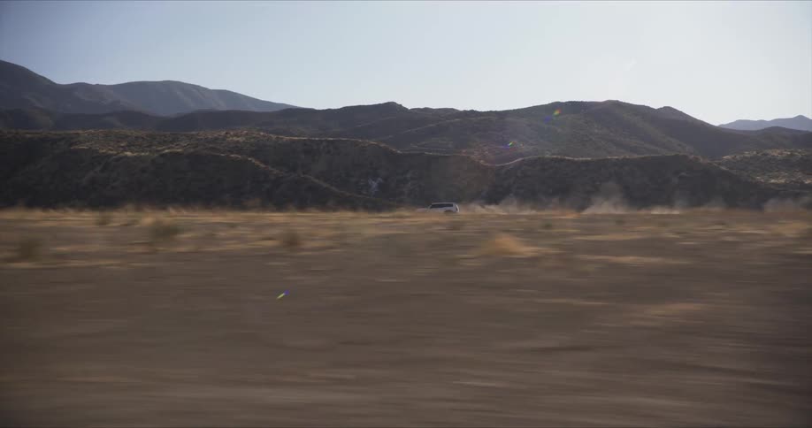A clip of a car riding along the grassland