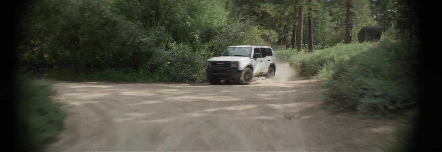 White offroad vehicle making a turn on a forest trail