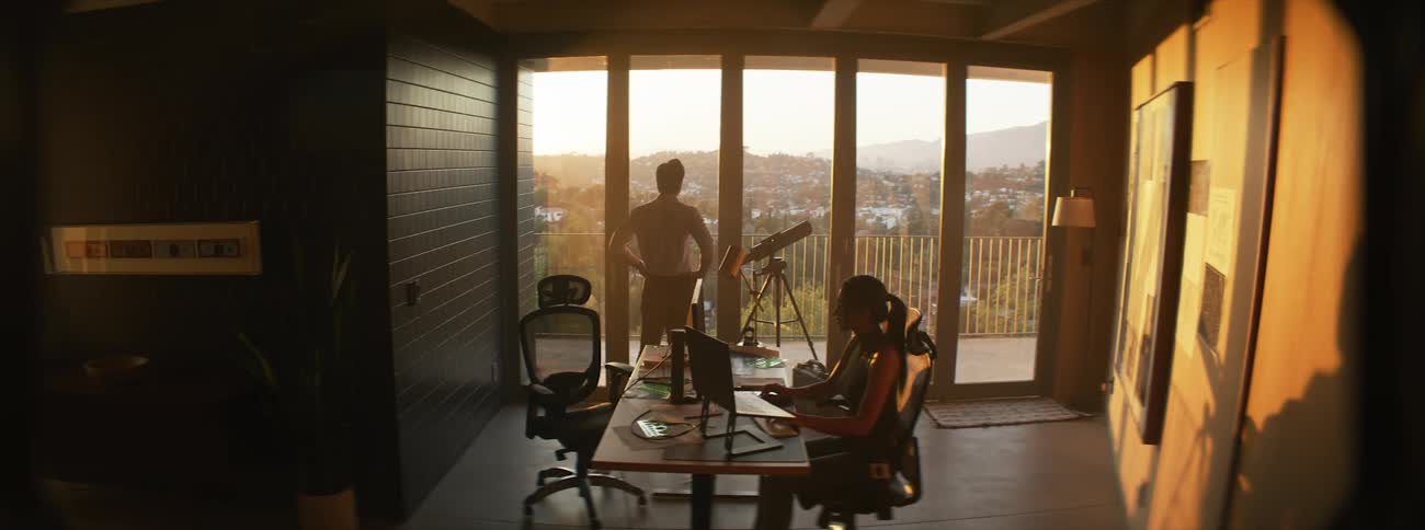 Woman and a man in an office environment sitting working