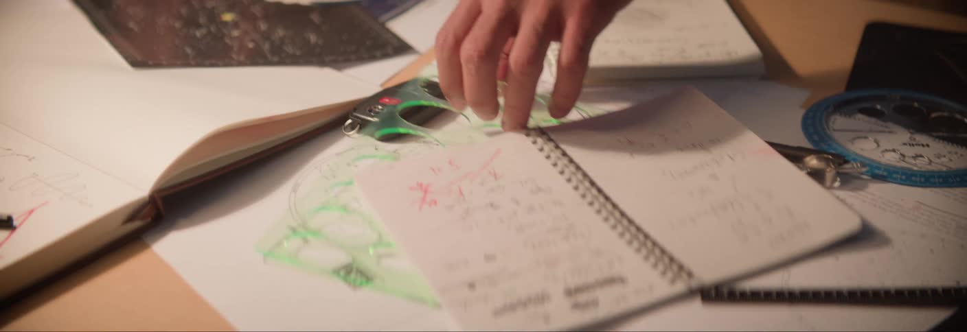 A man searches on his desk and finds his key fob