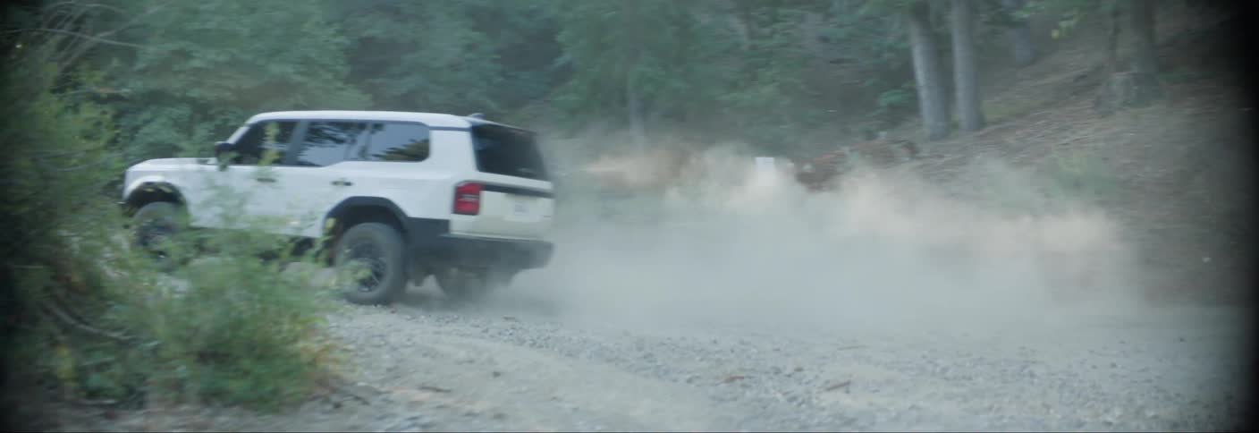 White offroad car turning a corner on a trail and going uphill
