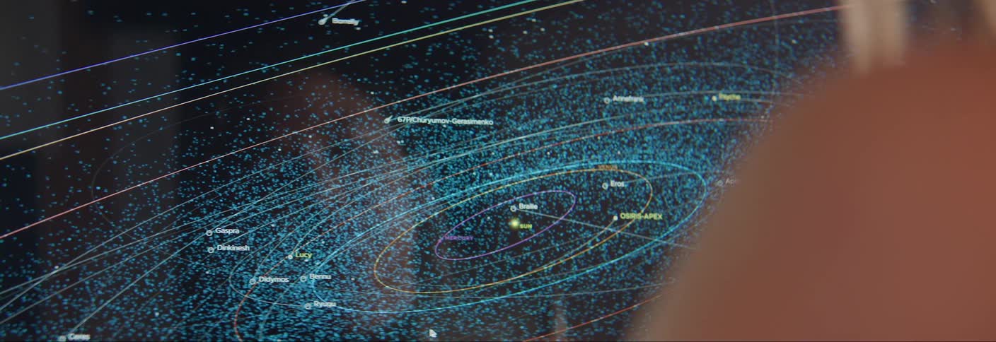 A digital representation of the solar system with a complex network of orbits and celestial bodies displayed on a screen
