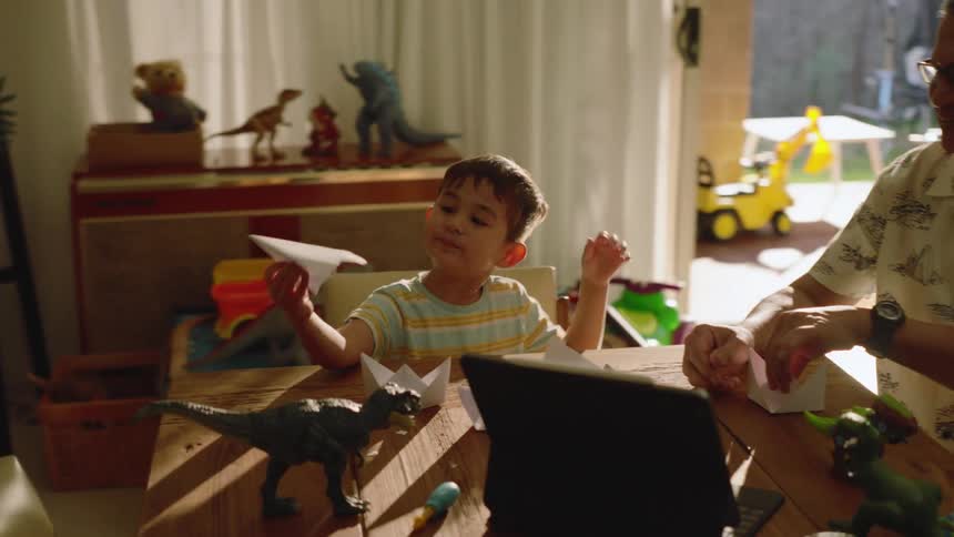 A clip of a kid playing with paper plane