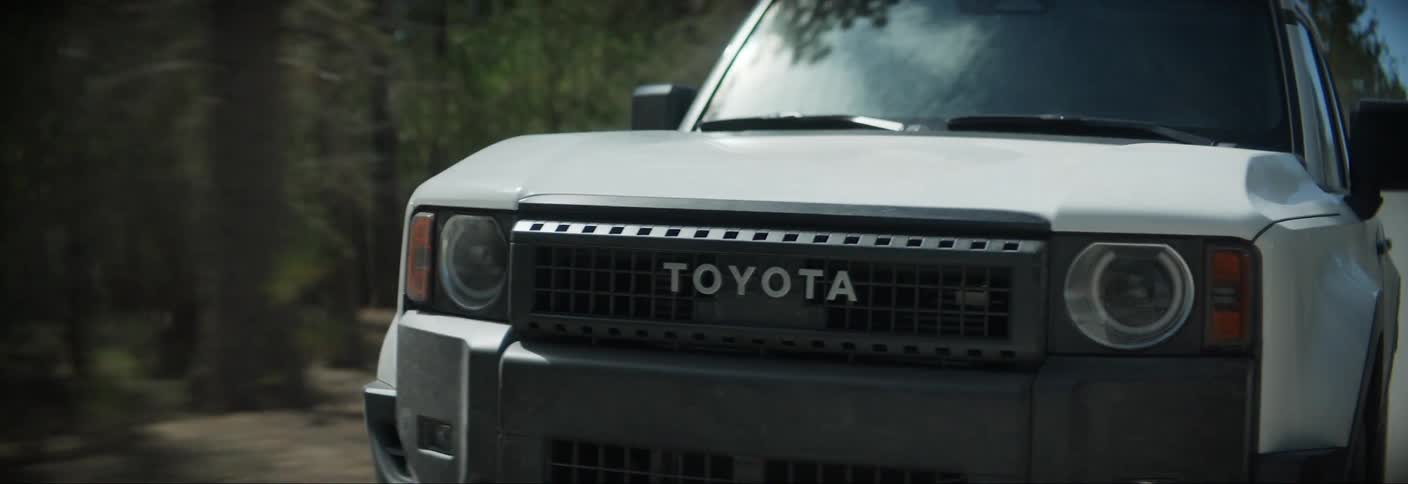 Toyota pickup truck traveling on a dirt road