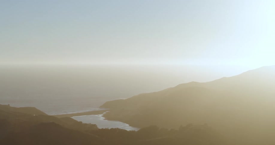 Fog covers the coast and nearby mountainous terrain