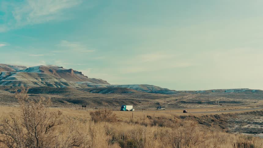 Landscape of a mountain valley and a highway with vehicle traffic
