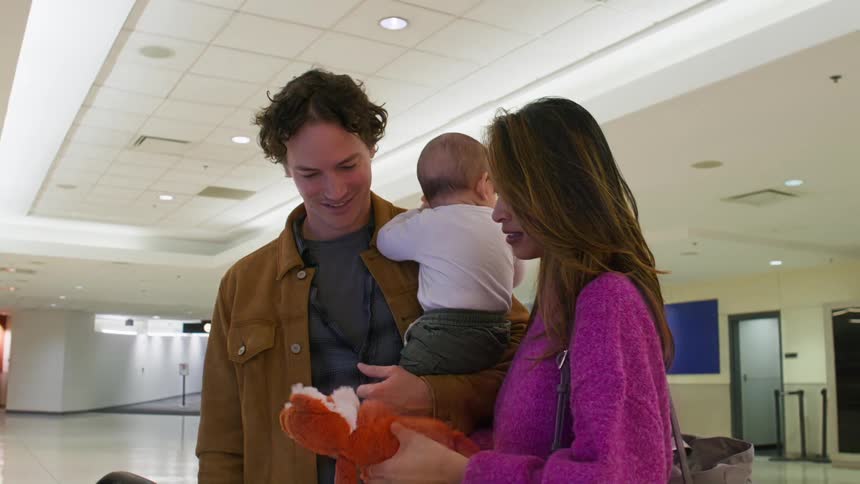 Couple with a small baby at an airport