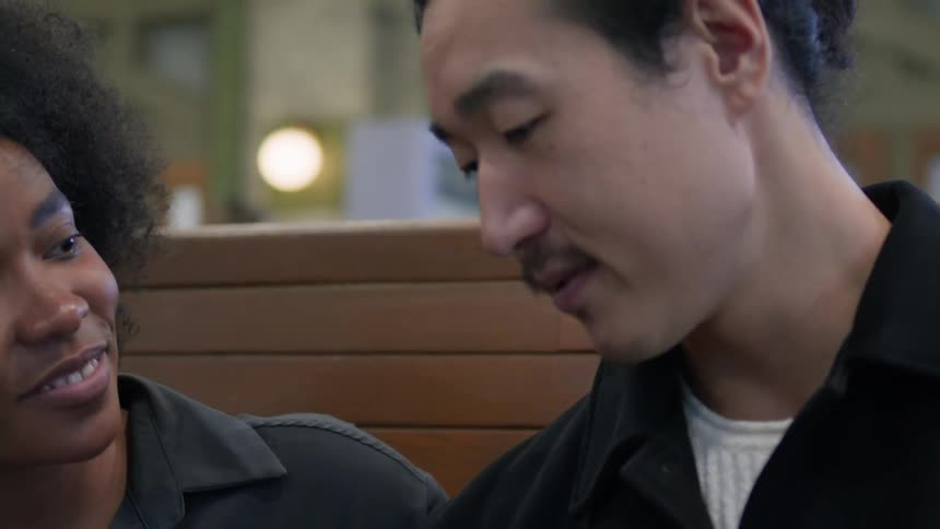 Woman and man sitting talking on a bench