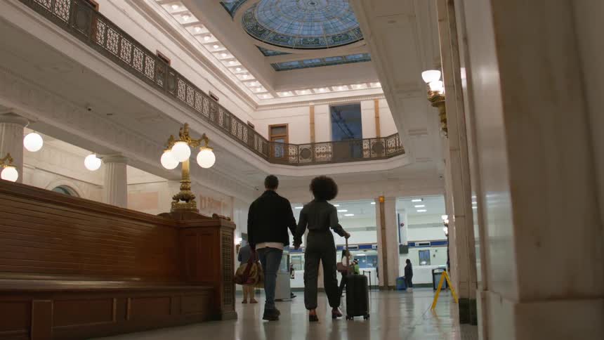 Couple holding hands and walking out of a terminal