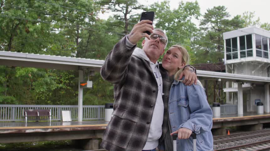 A clip of a couple taking a picture at the terminal