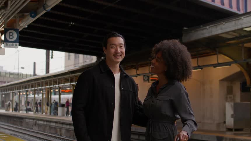 Happy couple hugging in a subway station