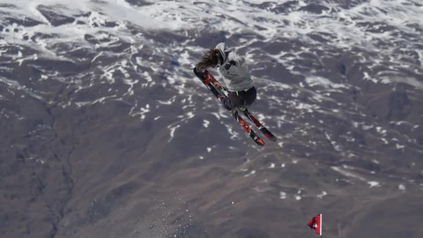 A skier jumps on a snow ramp