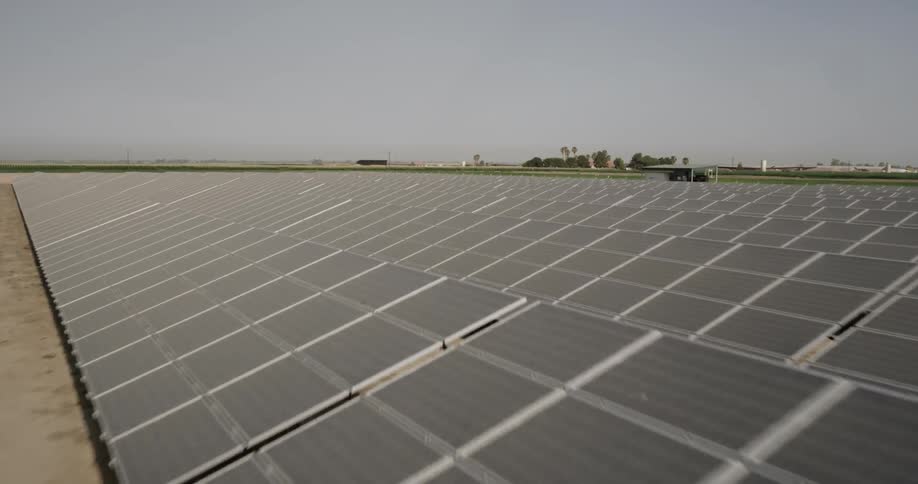A solar farm sits in an agricultural setting