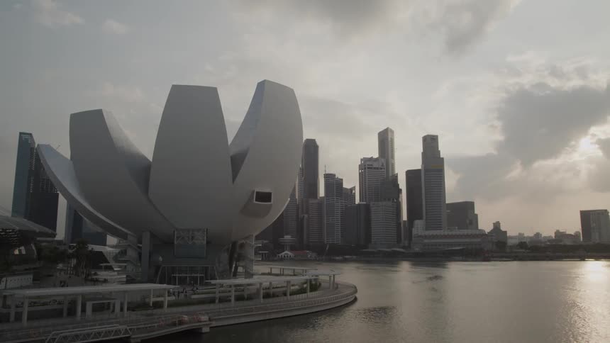 People walk around a structure near a city