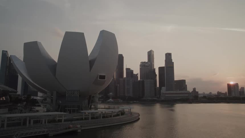 A large city is being filmed in the distance by a drone