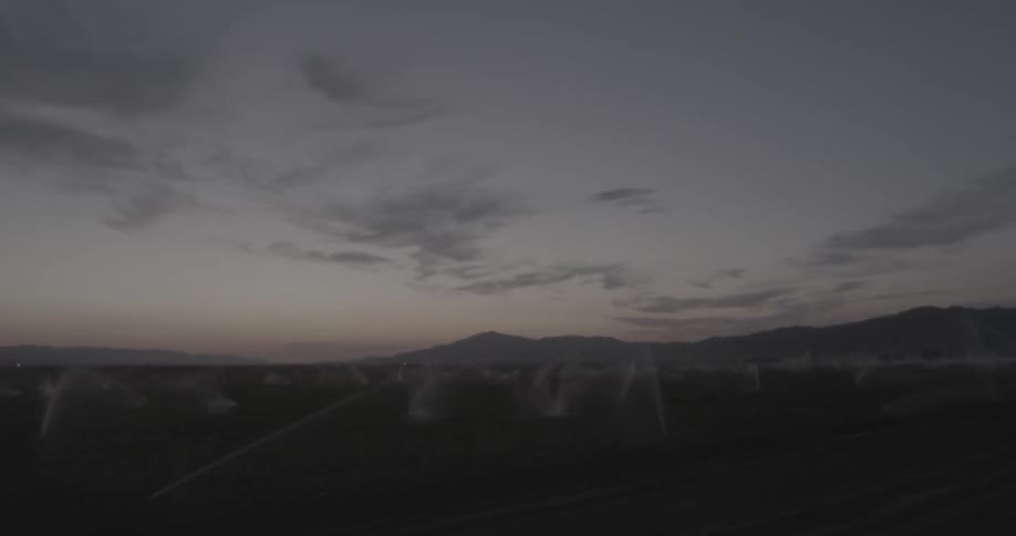 Water sprays crops in field