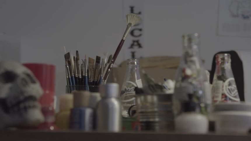Art supplies sit on a desktop