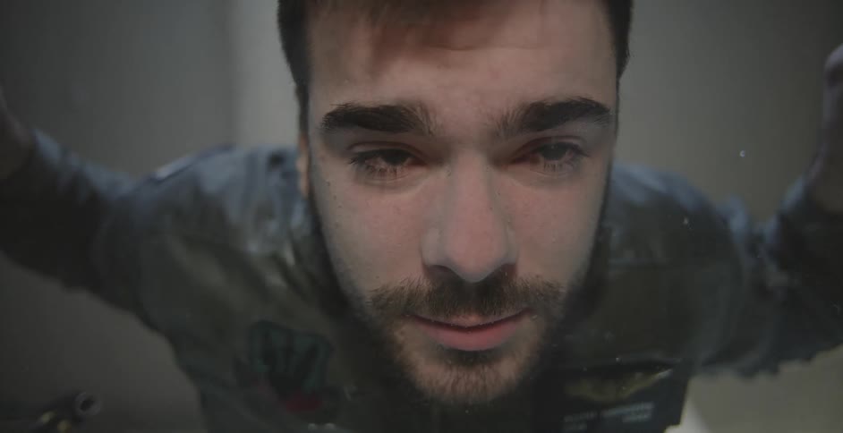 A man opens his eyes underwater
