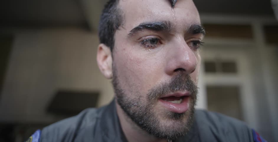 Close up of a man's face dripping with water