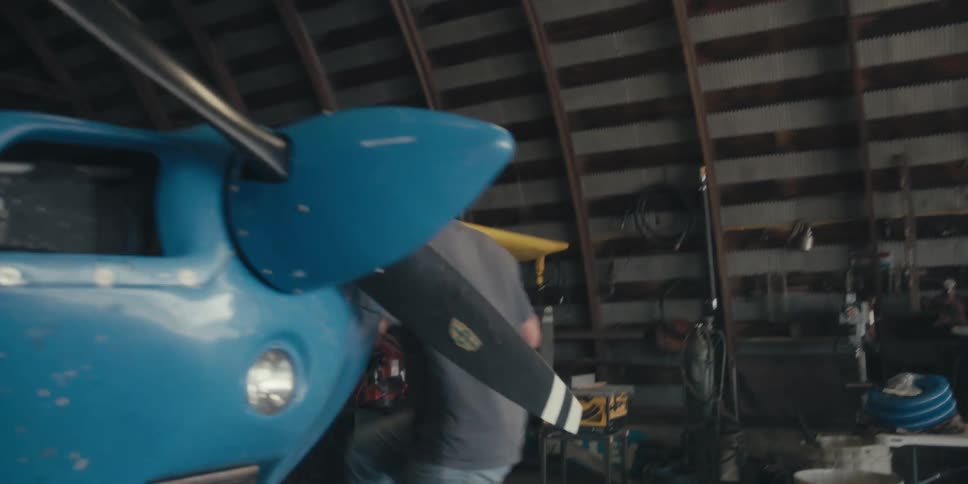 A man fuels his plane in the hangar
