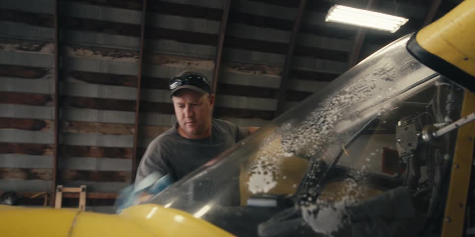 Man cleaning the windshield of an airplane