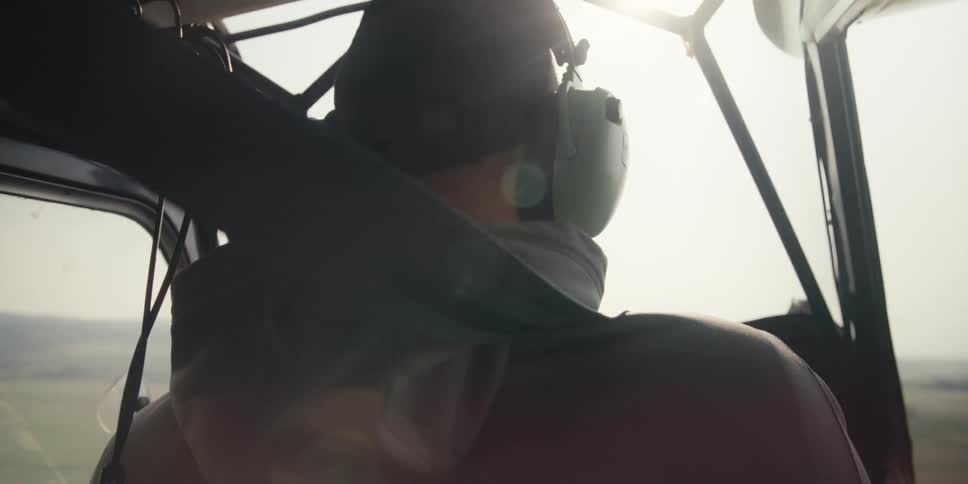 Sun flares through the cockpit window on Pilot high in the sky