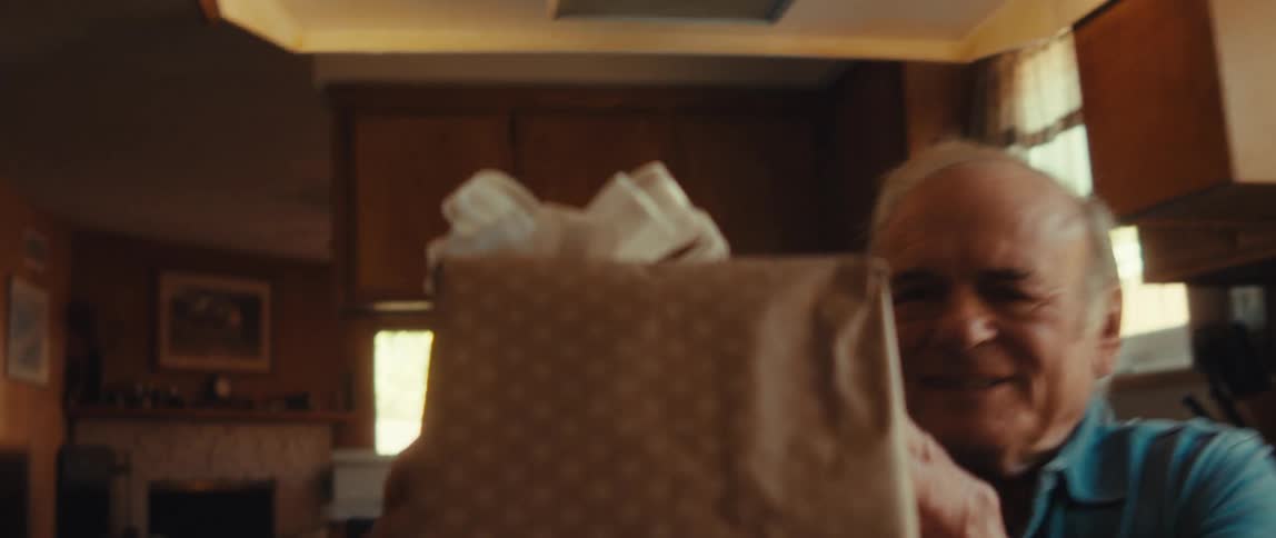 A clip of an elderly man lifting a gift box