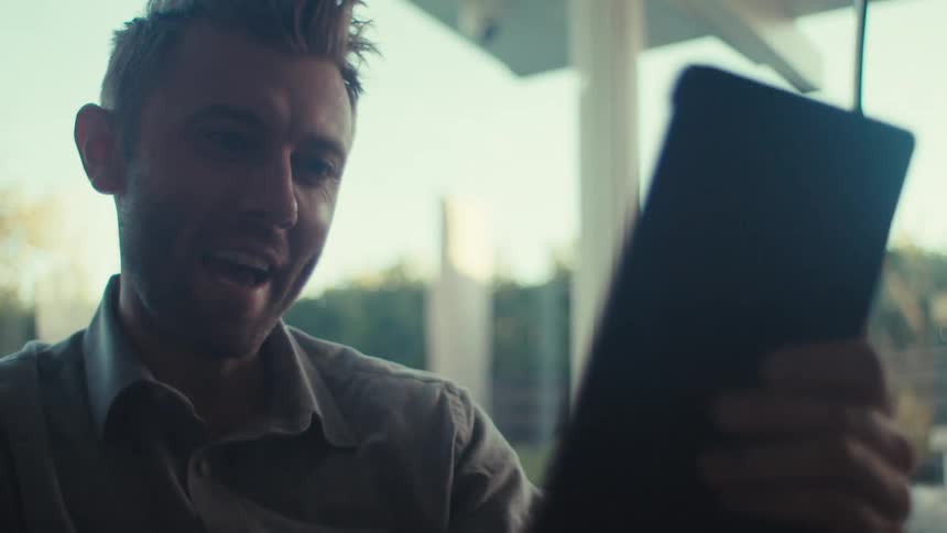 A man is doing a video call on his tablet