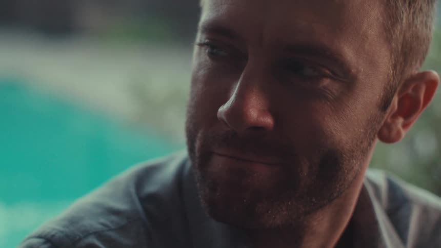 A clip of a man beside a pool
