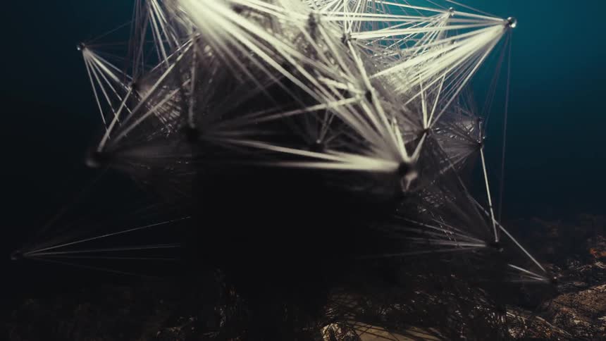 An abstract gray object underwater moving randomly and growing in all directions