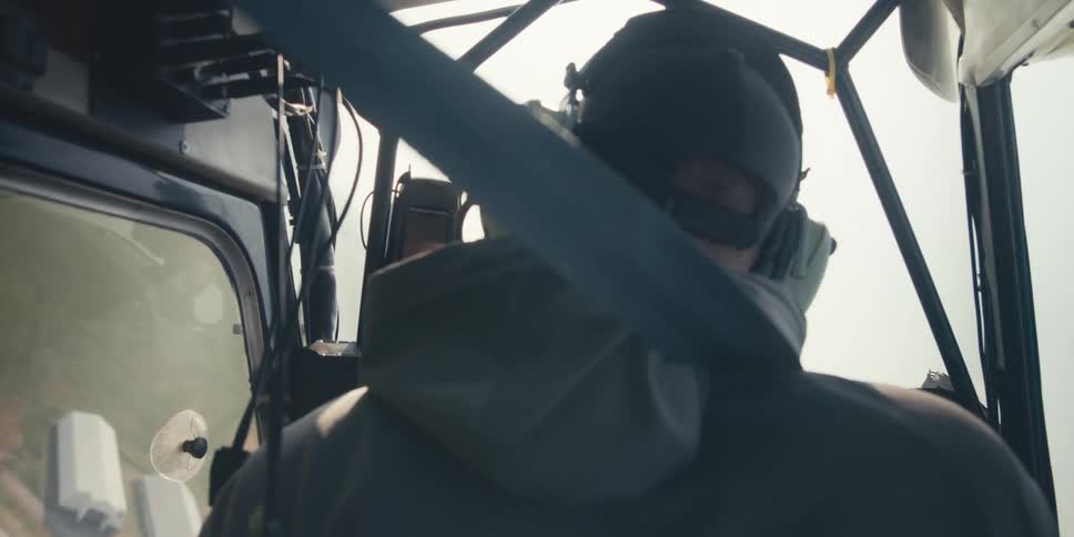 Person with headphones flying a plane