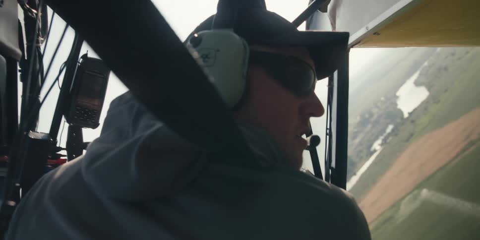 A man surveys the center pivot irrigation from an airplane
